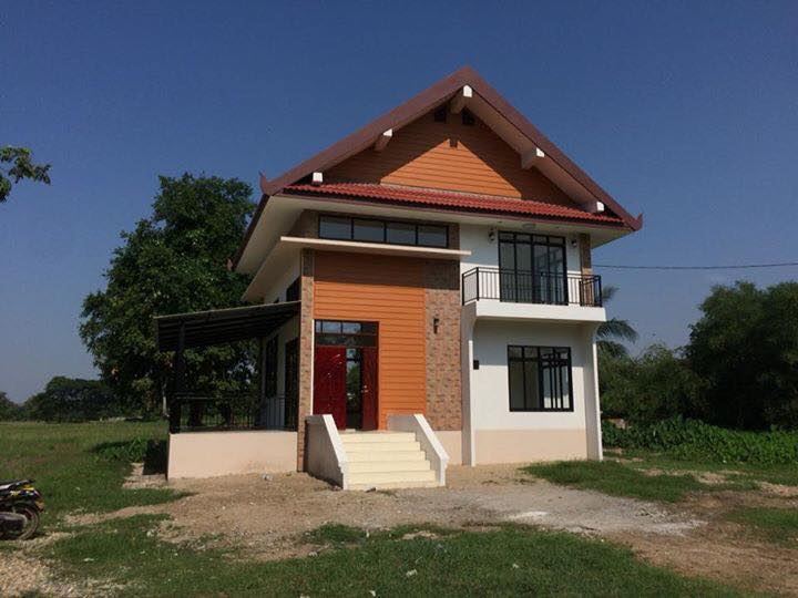 House by the Paddy Fields — long, low residence on the edge of a working paddy.